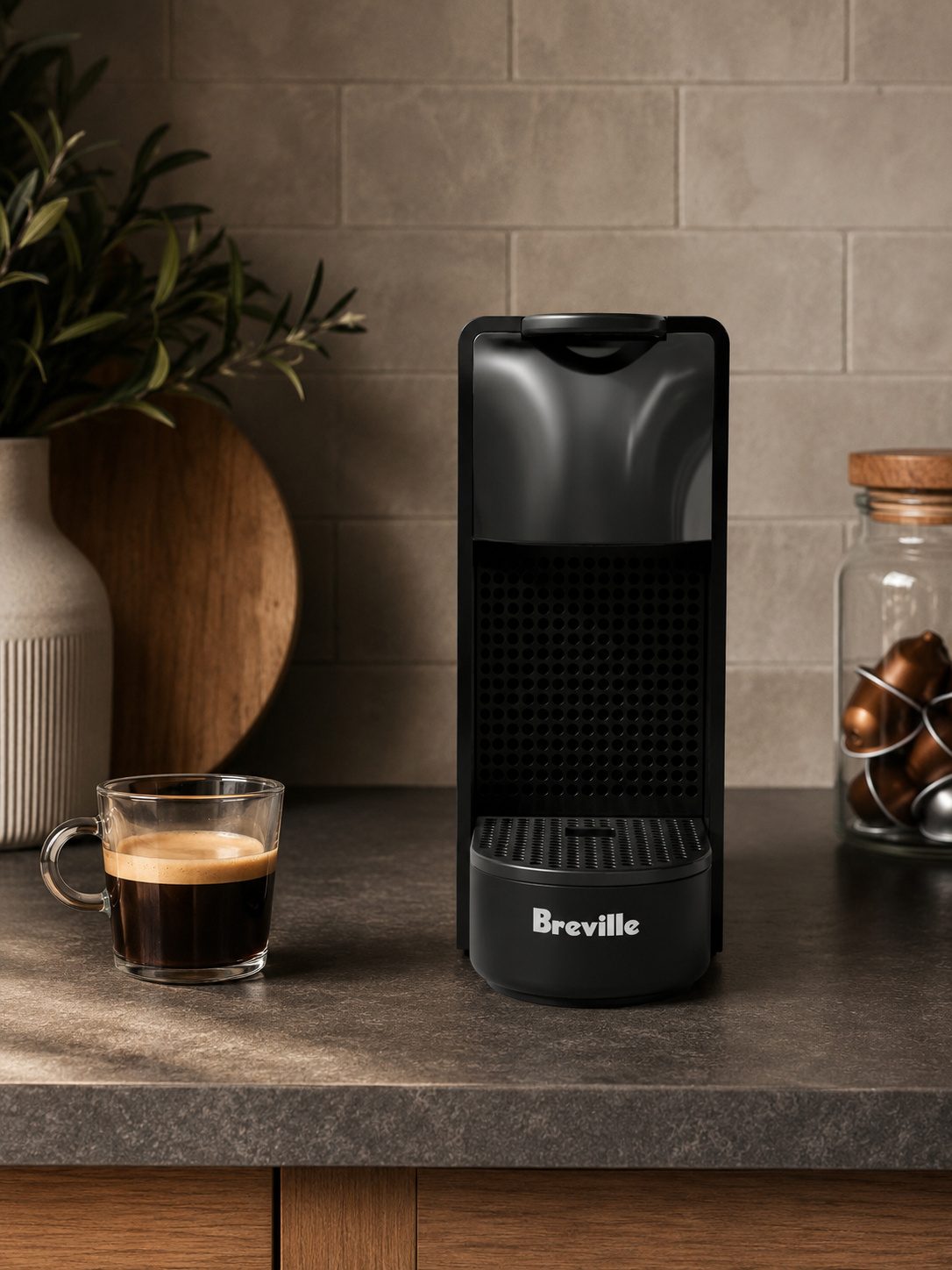 Nespresso Essenza Mini pod espresso machine in black on a kitchen counter